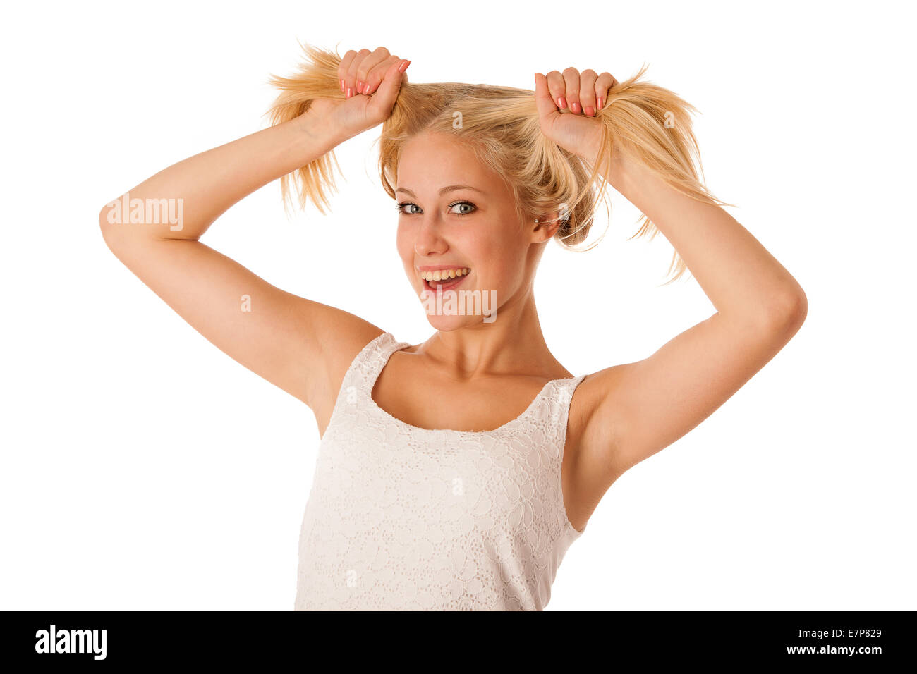 Beautiful young blonde woman holds hair in her hand gesturing excitement isolated over white background Stock Photo