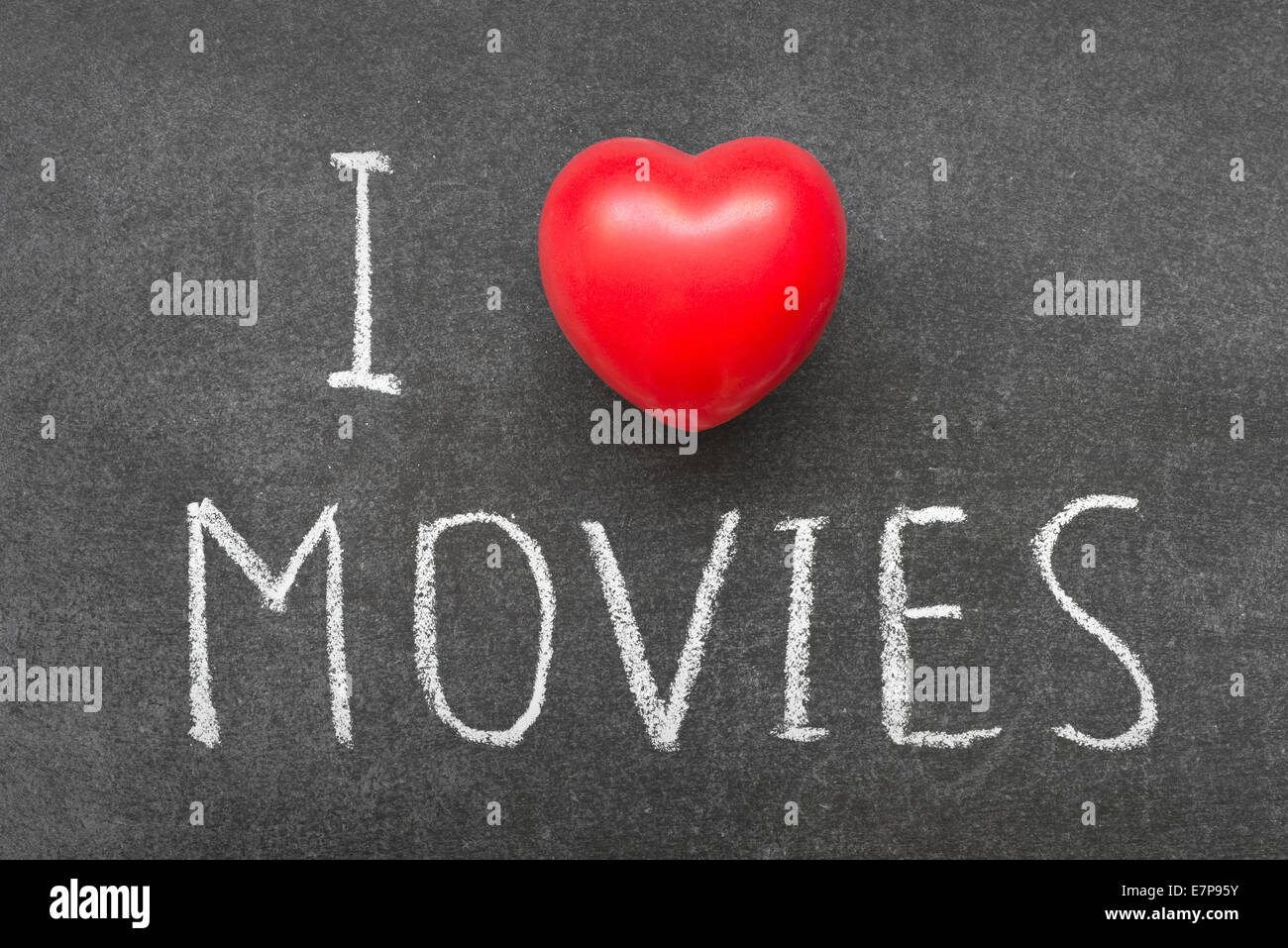 I love MOVIES phrase handwritten on chalkboard with heart symbol instead of O Stock Photo