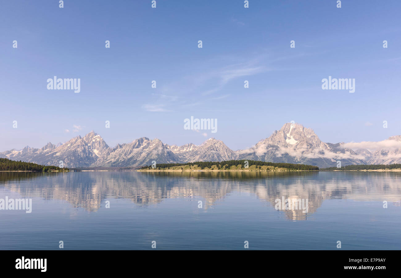 View across Jenny Lake with the Grand Tetons in the background on a fine morning in summer near Jackson, Wyoming, USA. Stock Photo