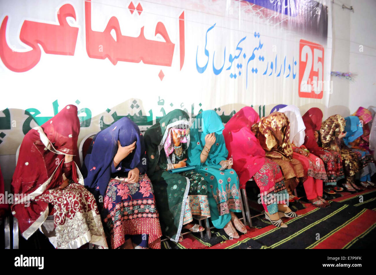 Group photo of bridegrooms during mass marriage ceremony organized by Jamat-e-Islami (JI) held at Markaz-e-Islami in Peshawar on Monday, September 22, 2014. Stock Photo