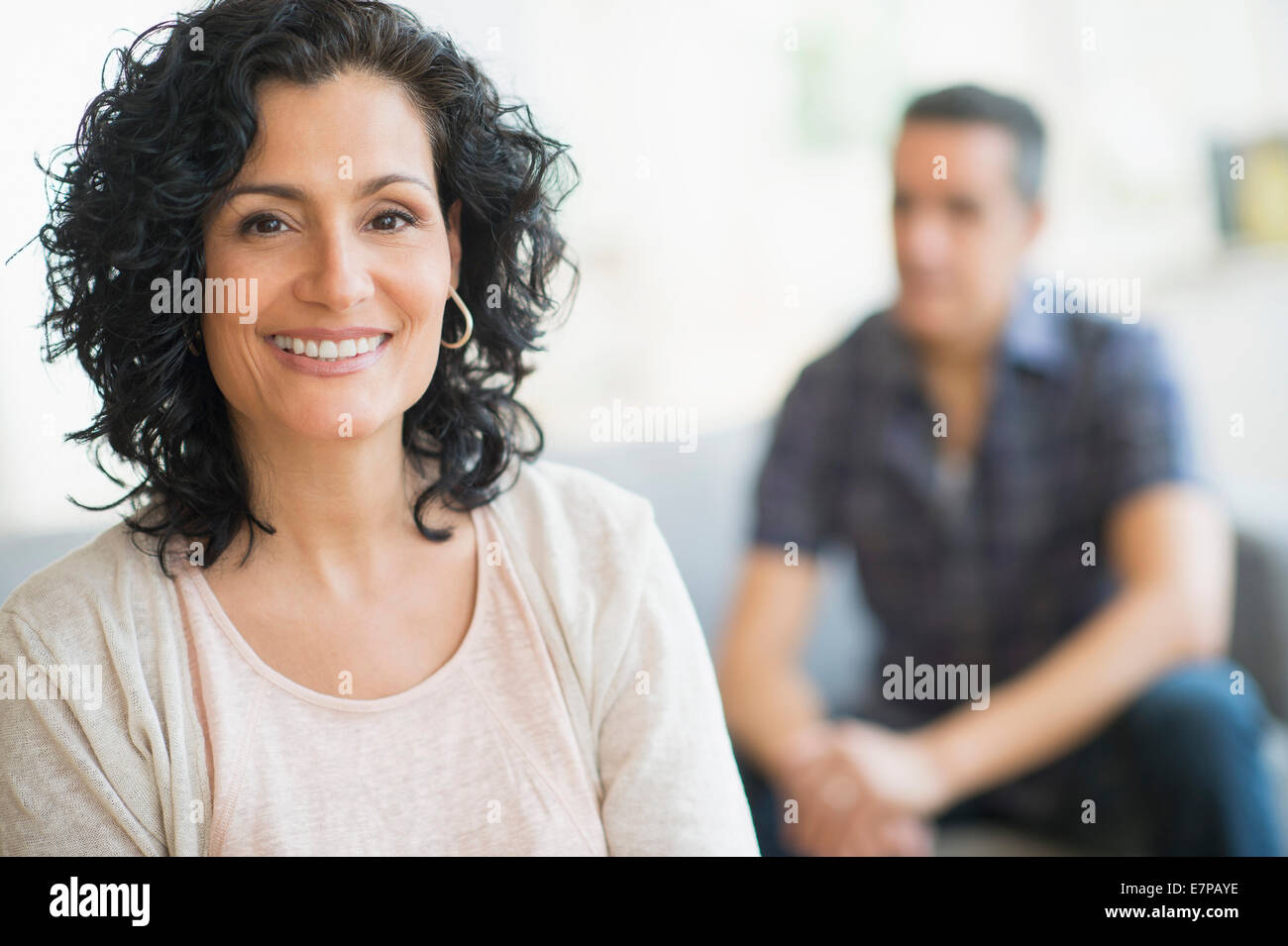 Portrait of smiling woman with man in background Stock Photo - Alamy