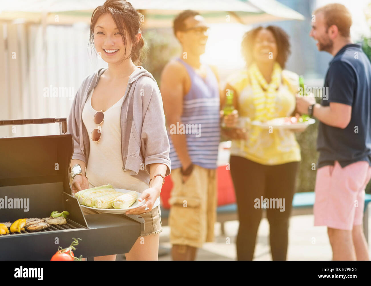 Group of friends enjoying barbeque Stock Photo