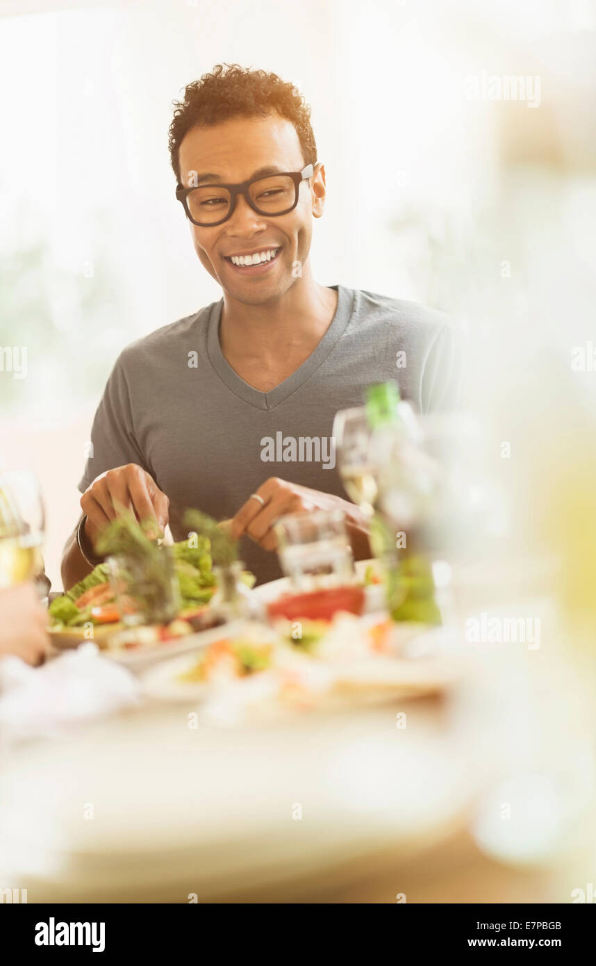 Young man enjoying dinner party Stock Photo