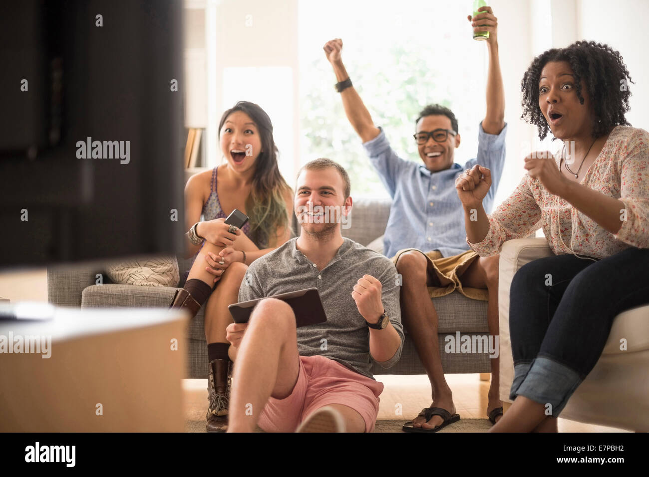 Group of friends watching television Stock Photo