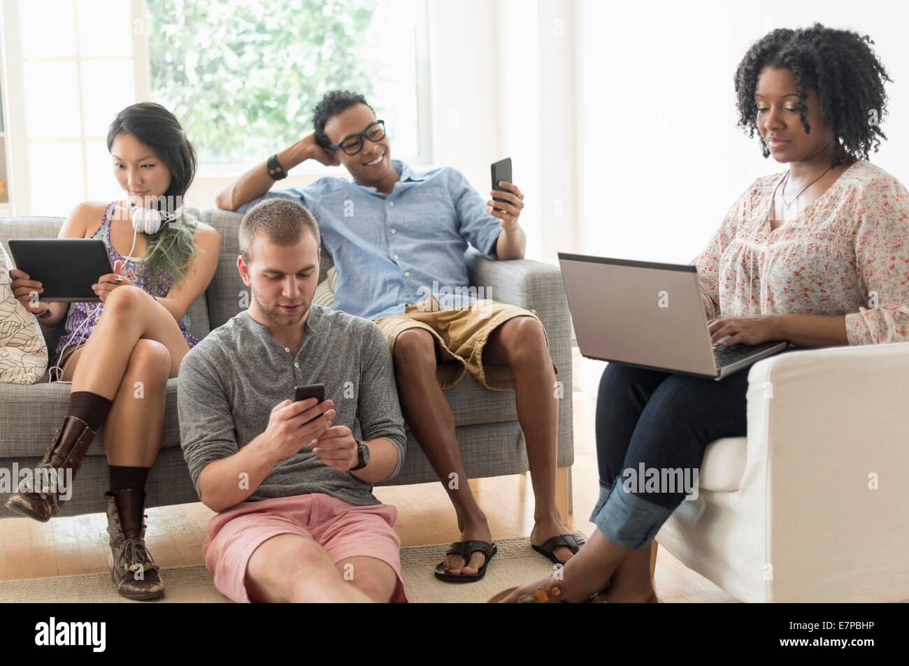 Friends hanging out in living room Stock Photo