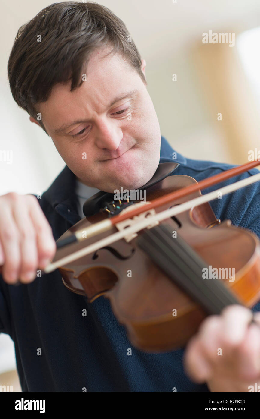 Man with down syndrome playing violin Stock Photo