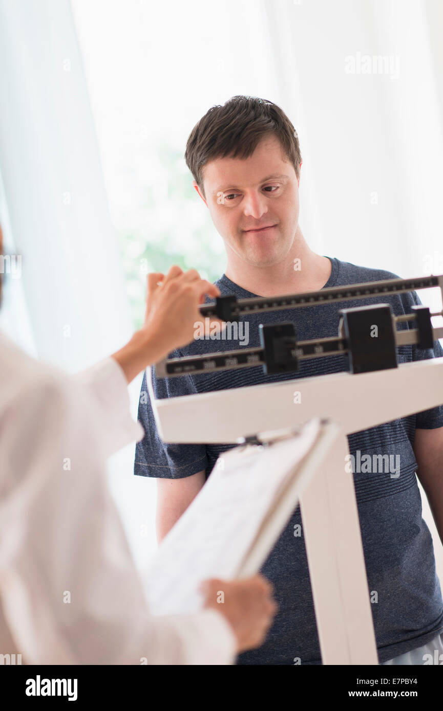 Man with down syndrome in doctors office Stock Photo