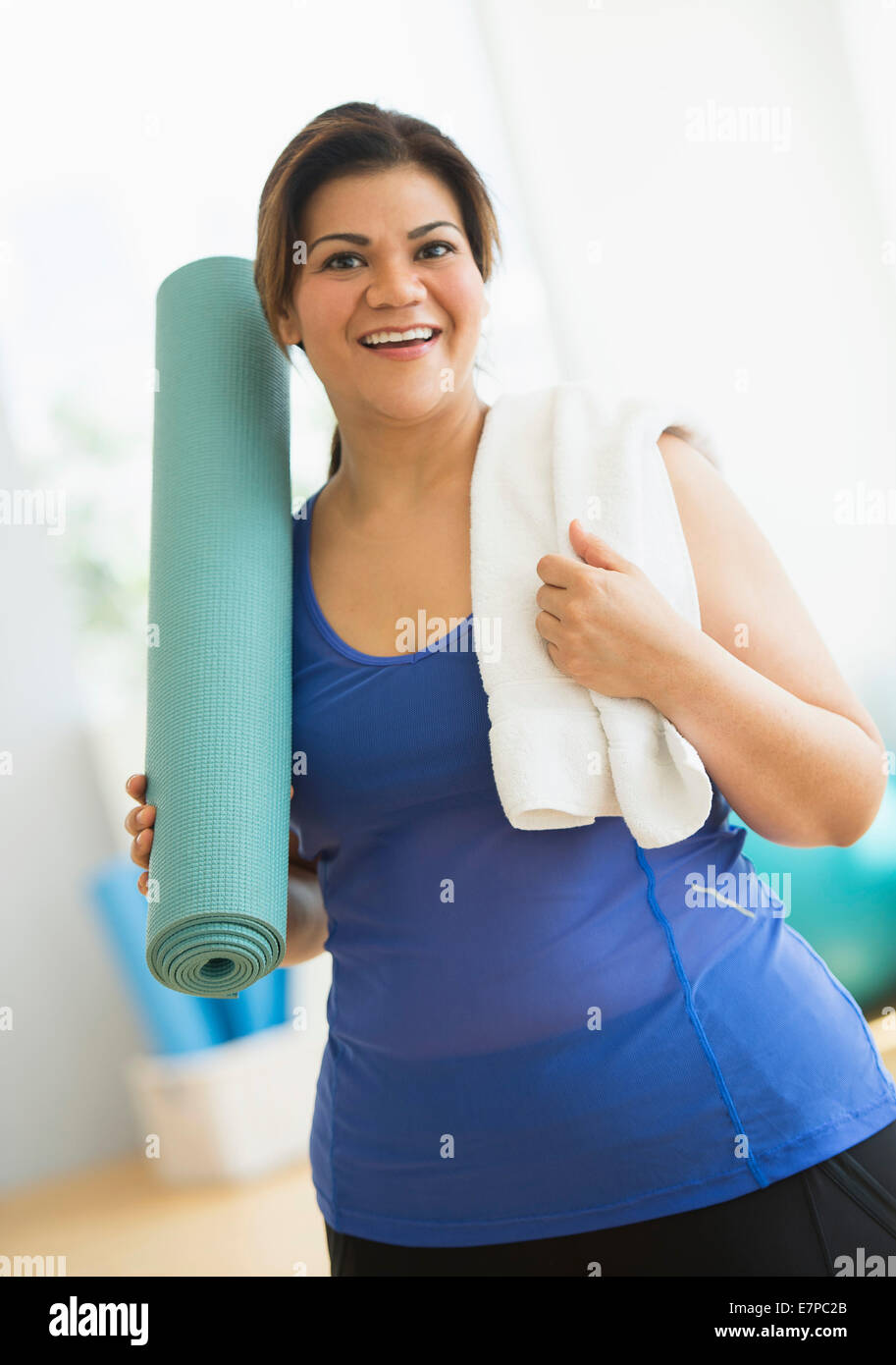 Woman holding exercise mat at gym Stock Photo Alamy