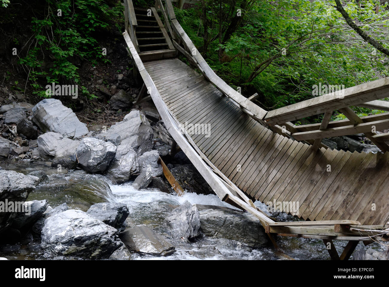 A wooden bridge destroyed by floodwater in the river, Gaspesie, Quebec, Canada Stock Photo