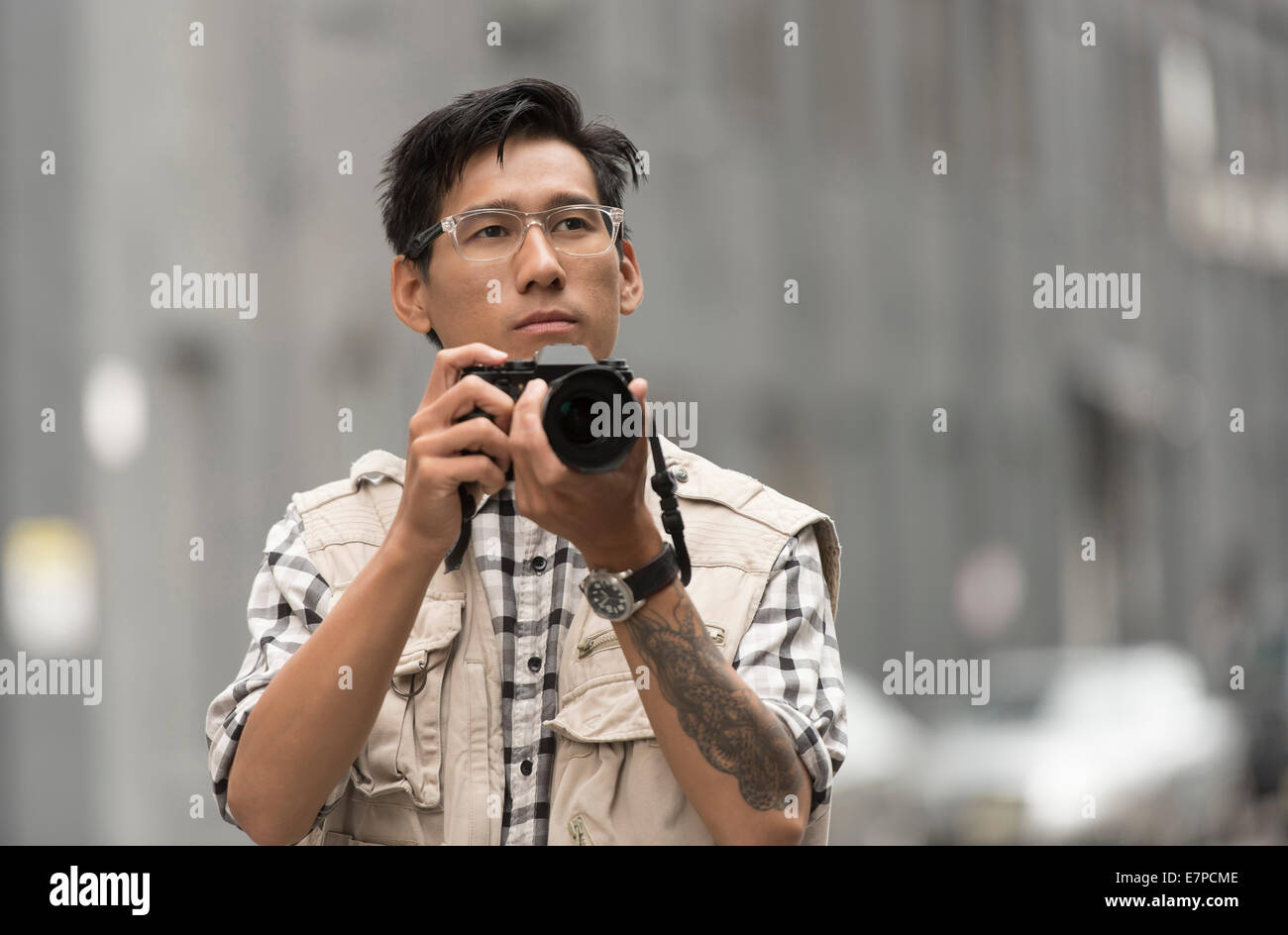 Portrait of man holding camera Stock Photo