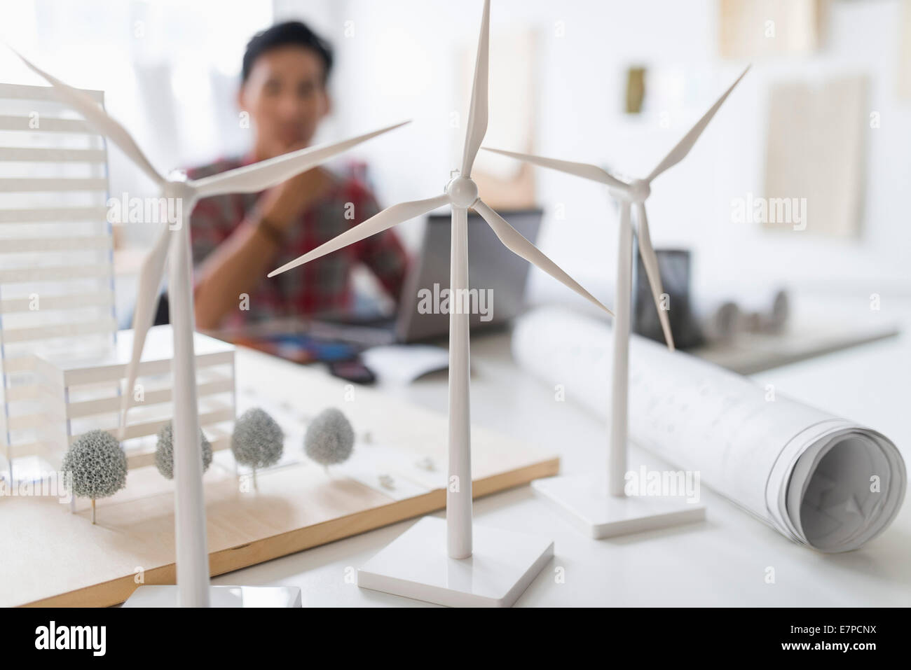 architect in background, Wind turbine models on desk Stock Photo
