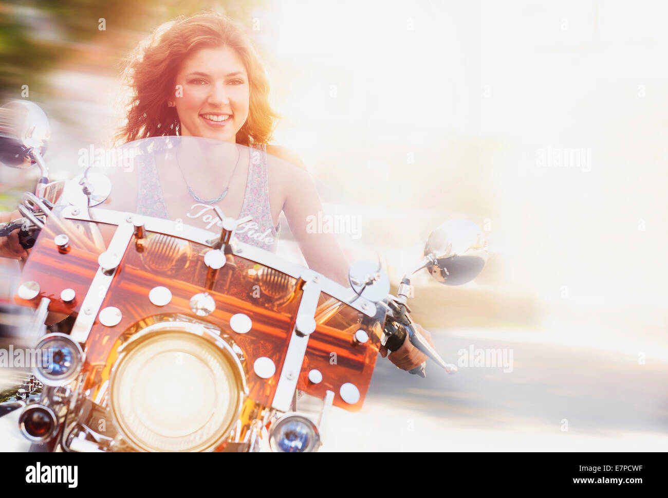 Young woman riding motorcycle Stock Photo