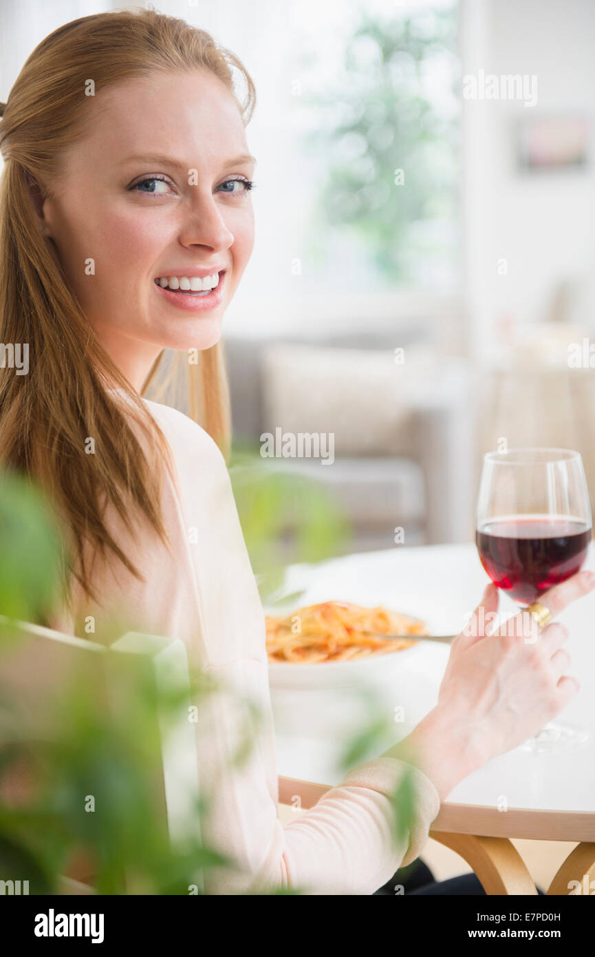 Woman having meal with red wine Stock Photo
