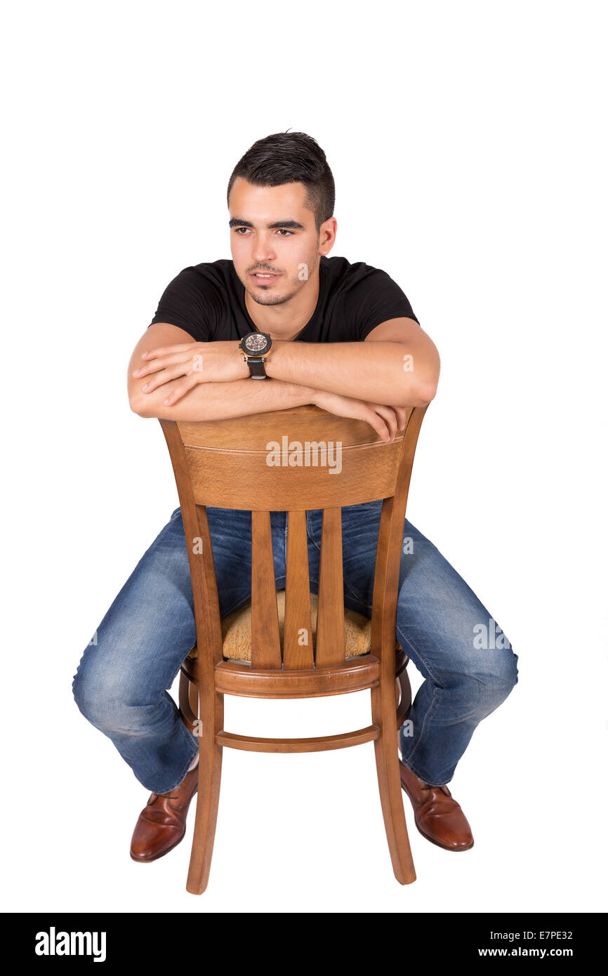 Young boy sitting on a chair on a white background Stock Photo