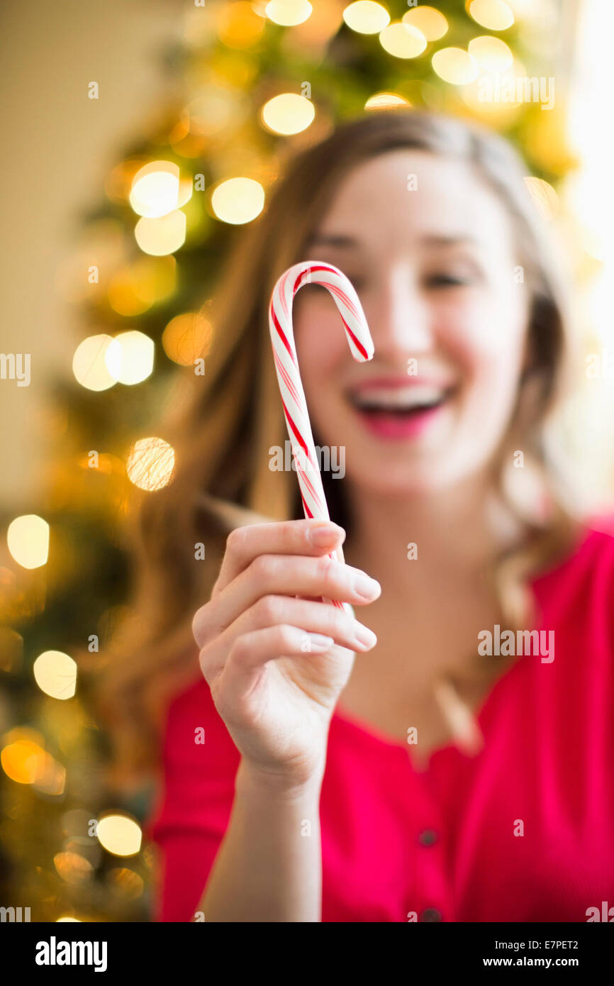 Young woman holding candy cane Stock Photo Alamy