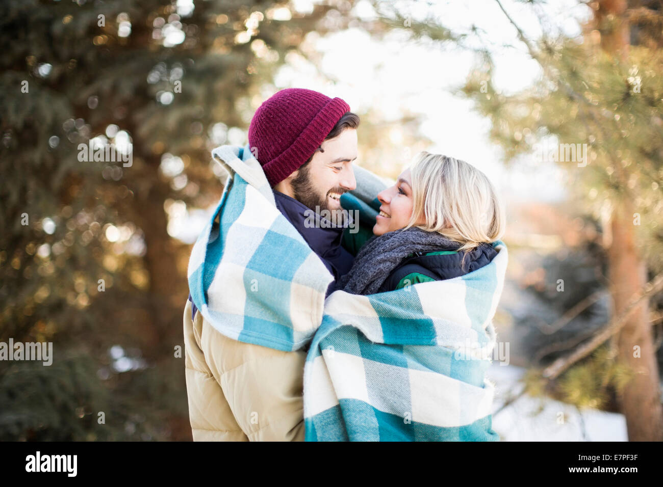 USA, Utah, Salt Lake City, Couple wrapped in blanket hugging outdoors Stock Photo