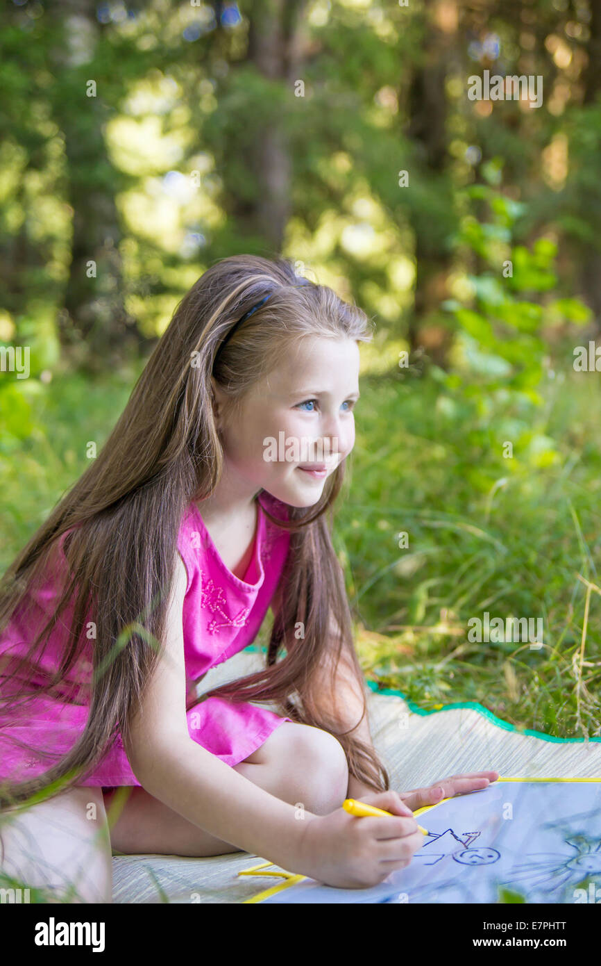 Little girl drawing outdoors Stock Photo