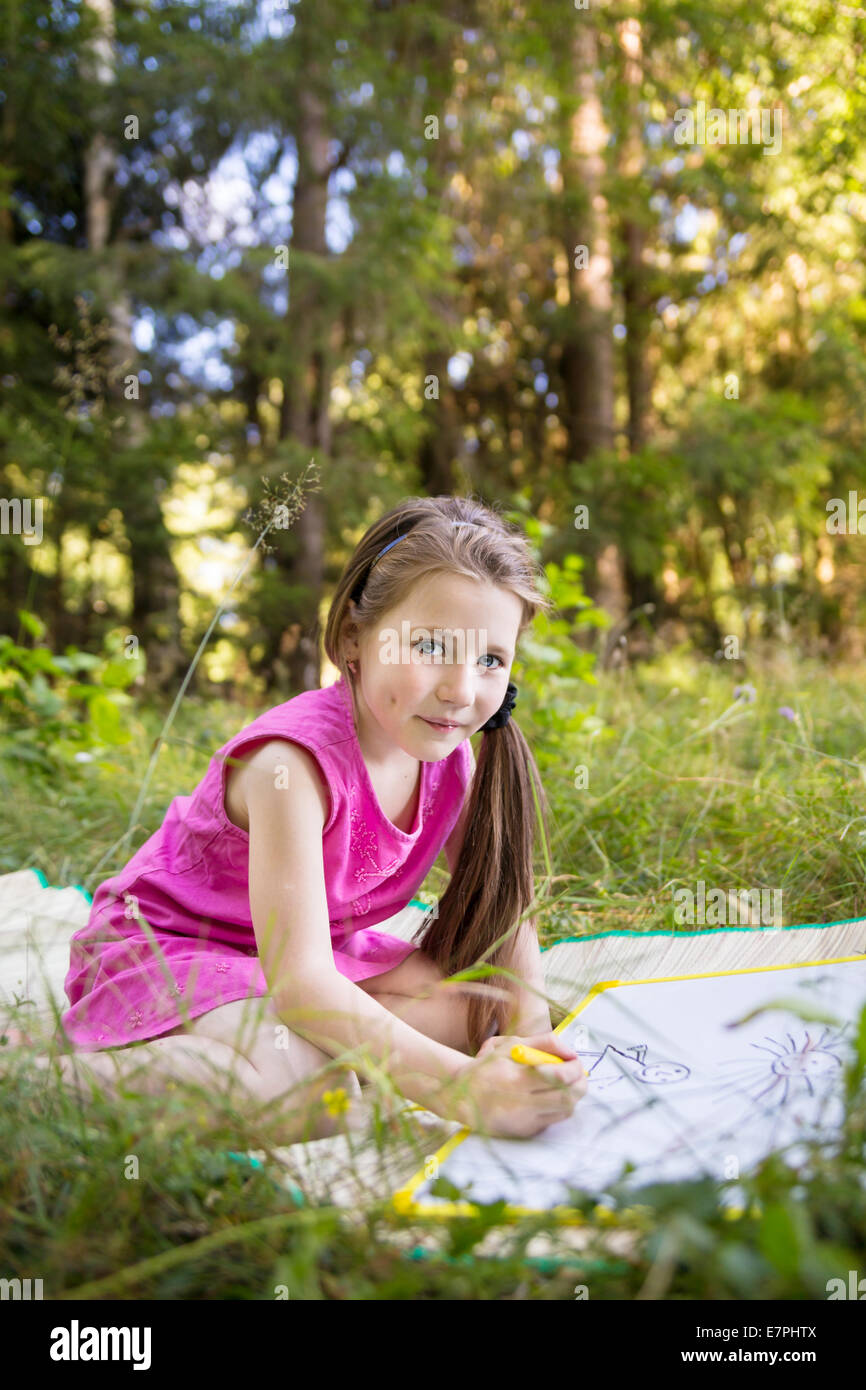 Little girl drawing outdoors Stock Photo