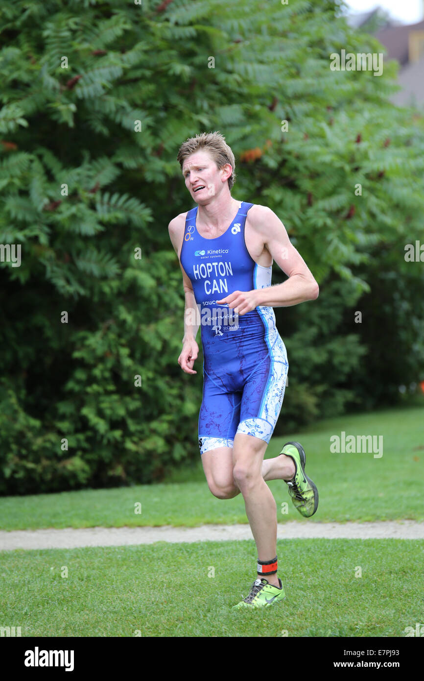 white man running body suit grass outdoor Stock Photo