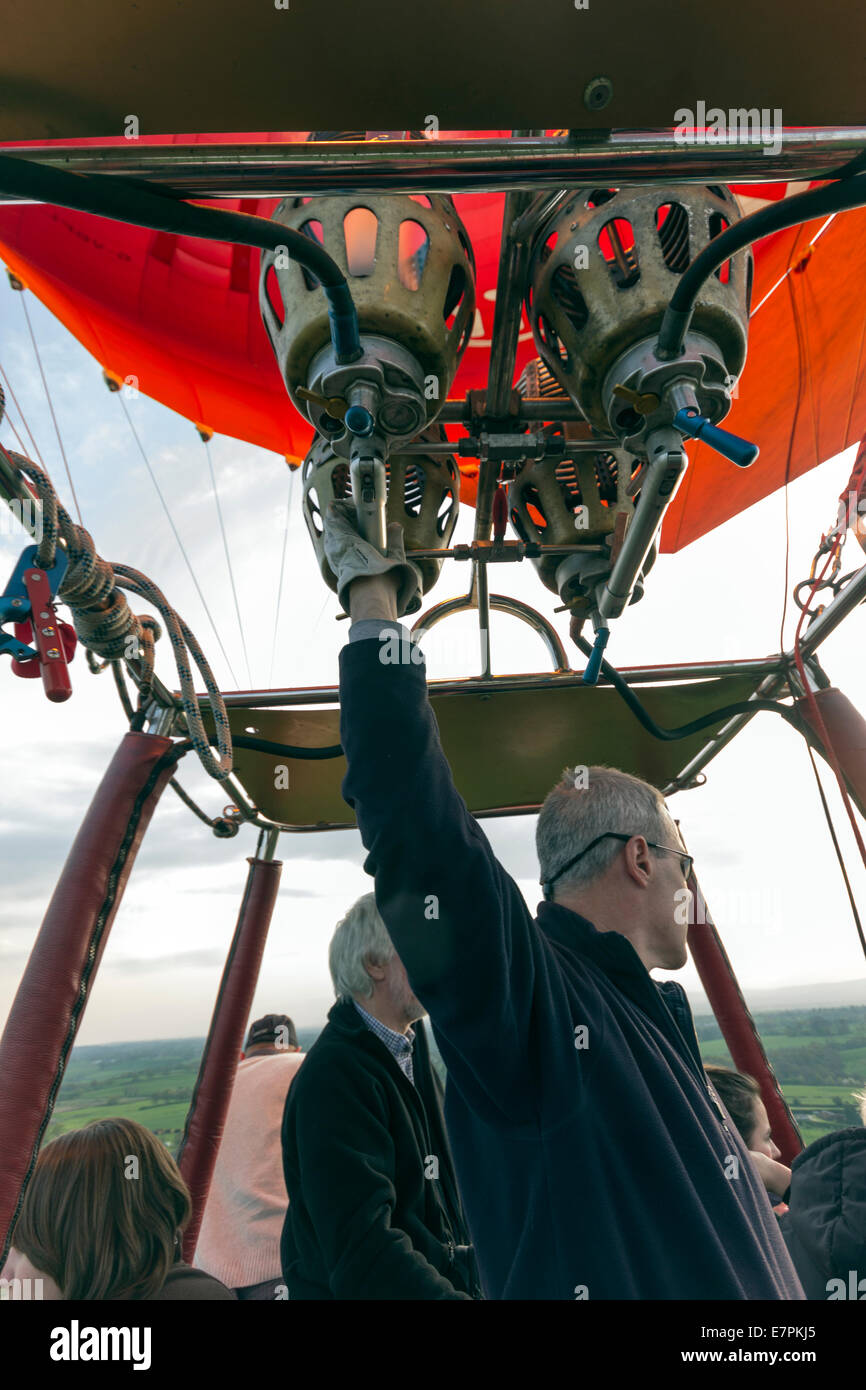 Pilot steering a hot air balloon with passengers enjoying the view,  Shropshire, UK Stock Photo - Alamy