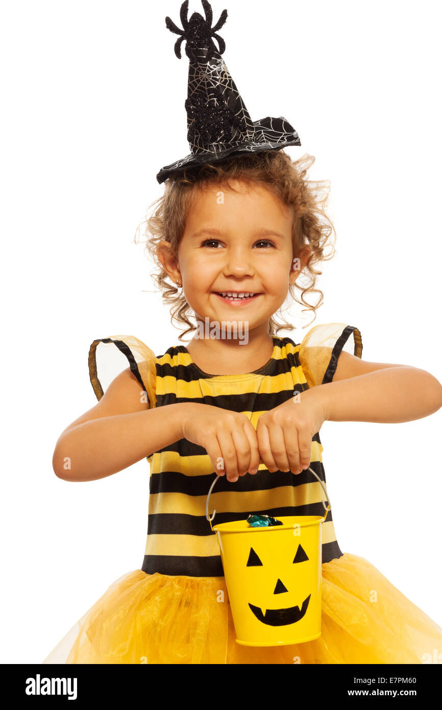 Little girl in bee costume with Halloween bucket Stock Photo