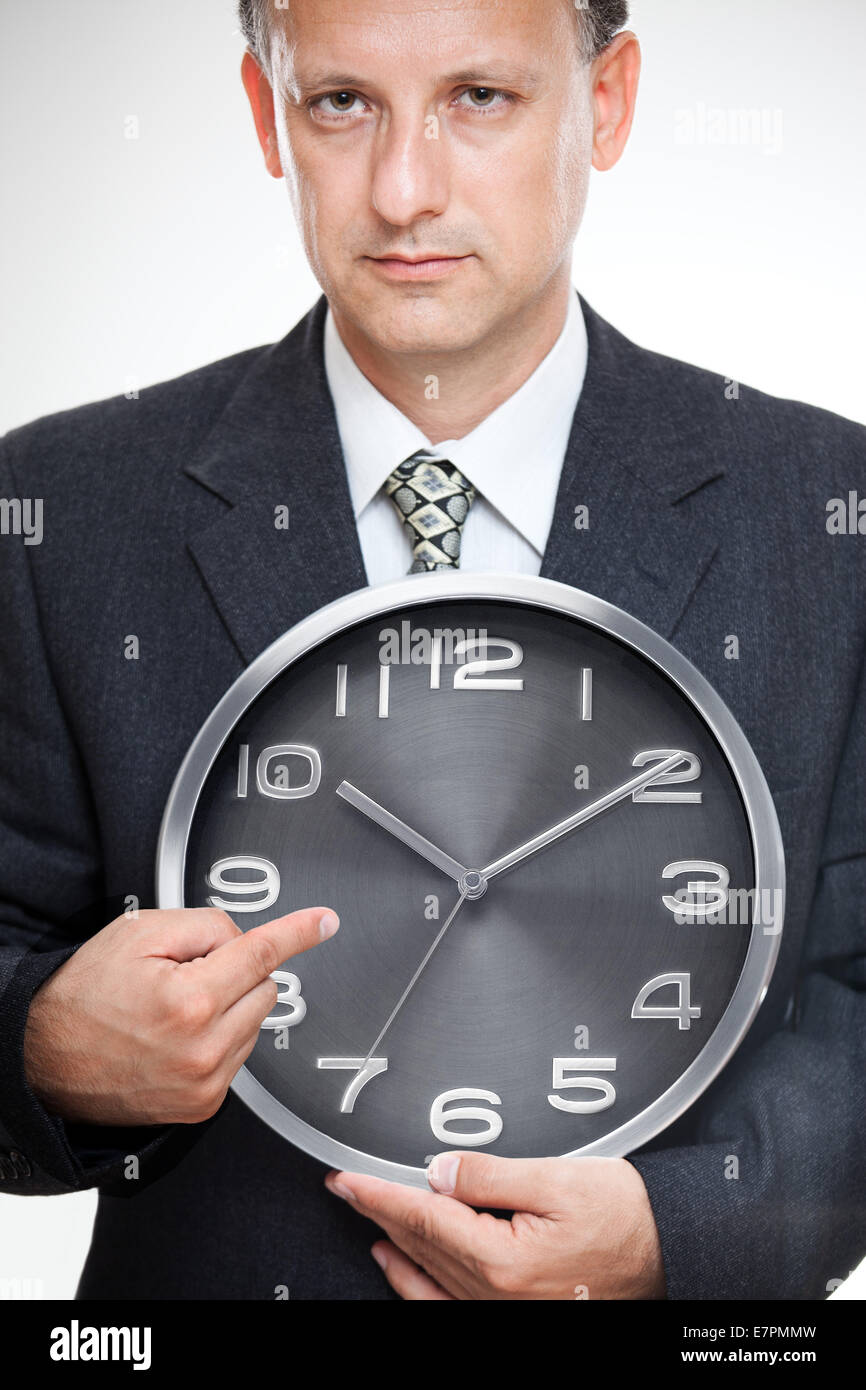 Business time. Businessman looking at his imaginary wristwatch worrying, being late concept. Stock Photo