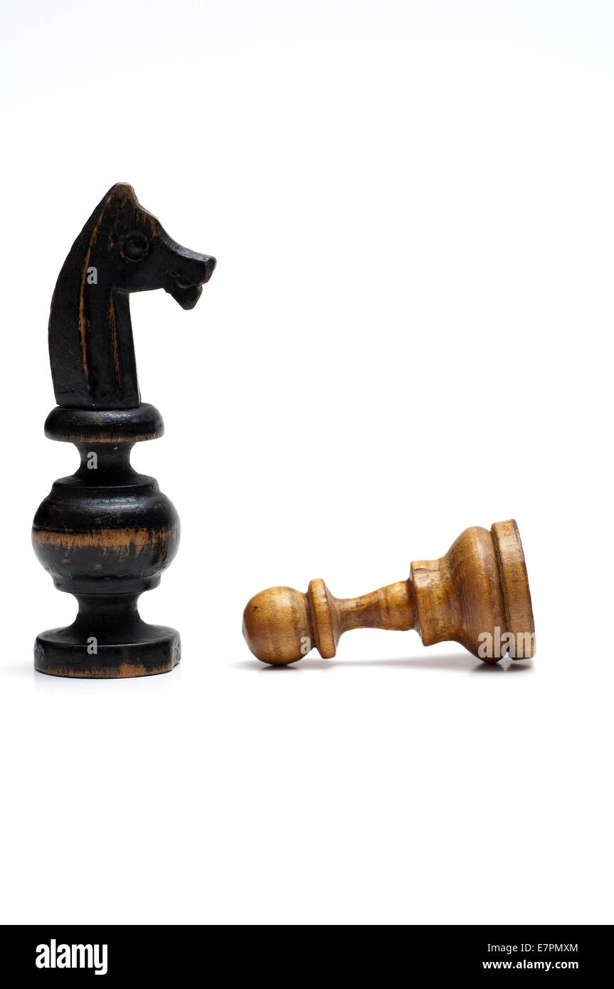 Chess pieces, horse and the fallen pawn together on white. Stock Photo