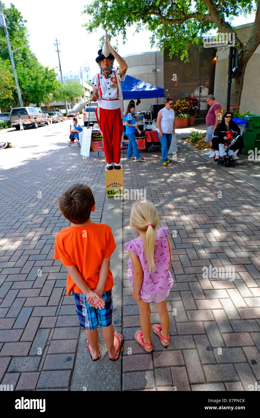 Children watch clown performs tricks at farmer's market Bradenton FL