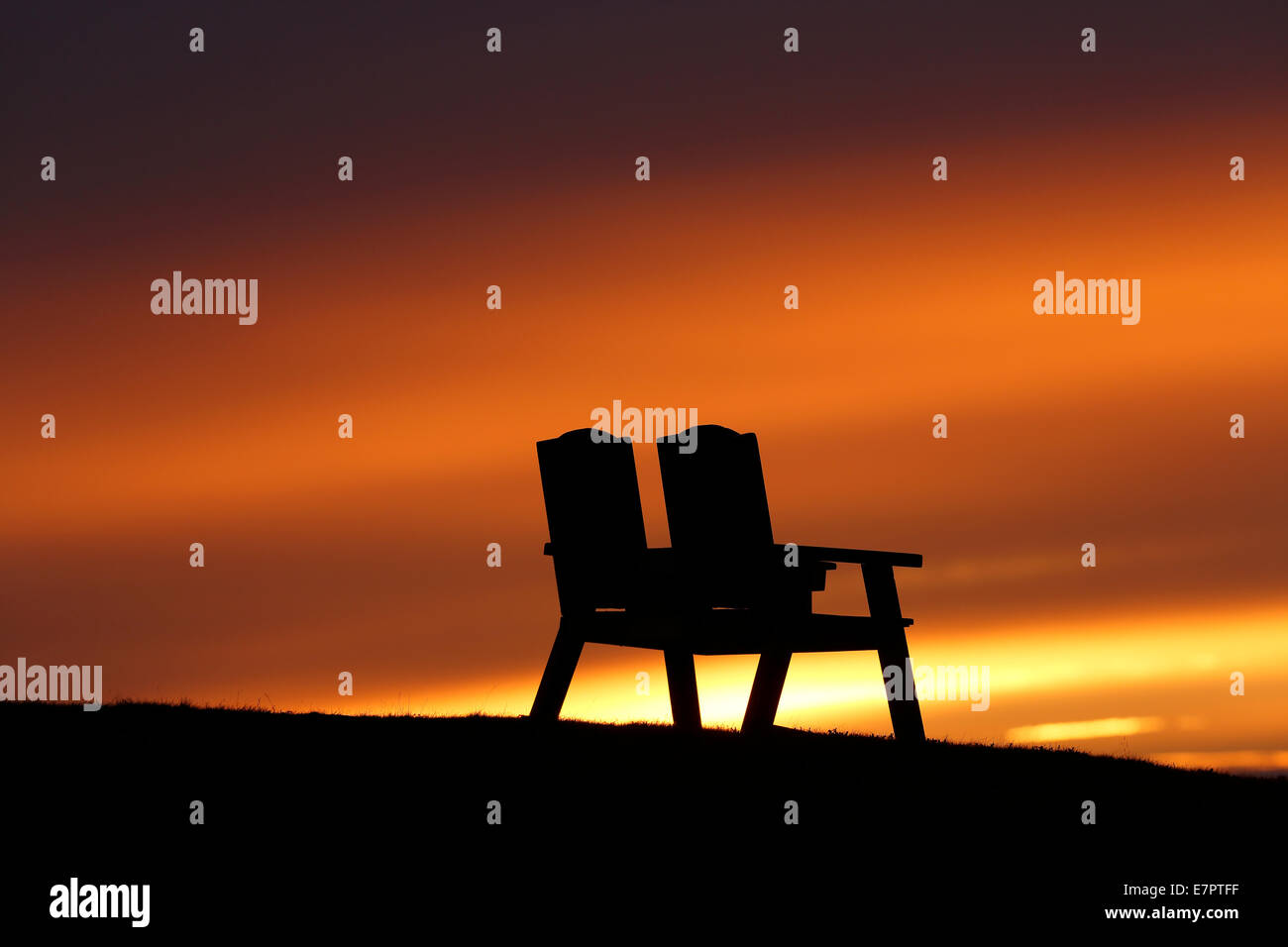 Twin chairs facing sunset on the Cabot Trail, Pleasant Bay, Cape Breton Island, Nova Scotia, Canada Stock Photo