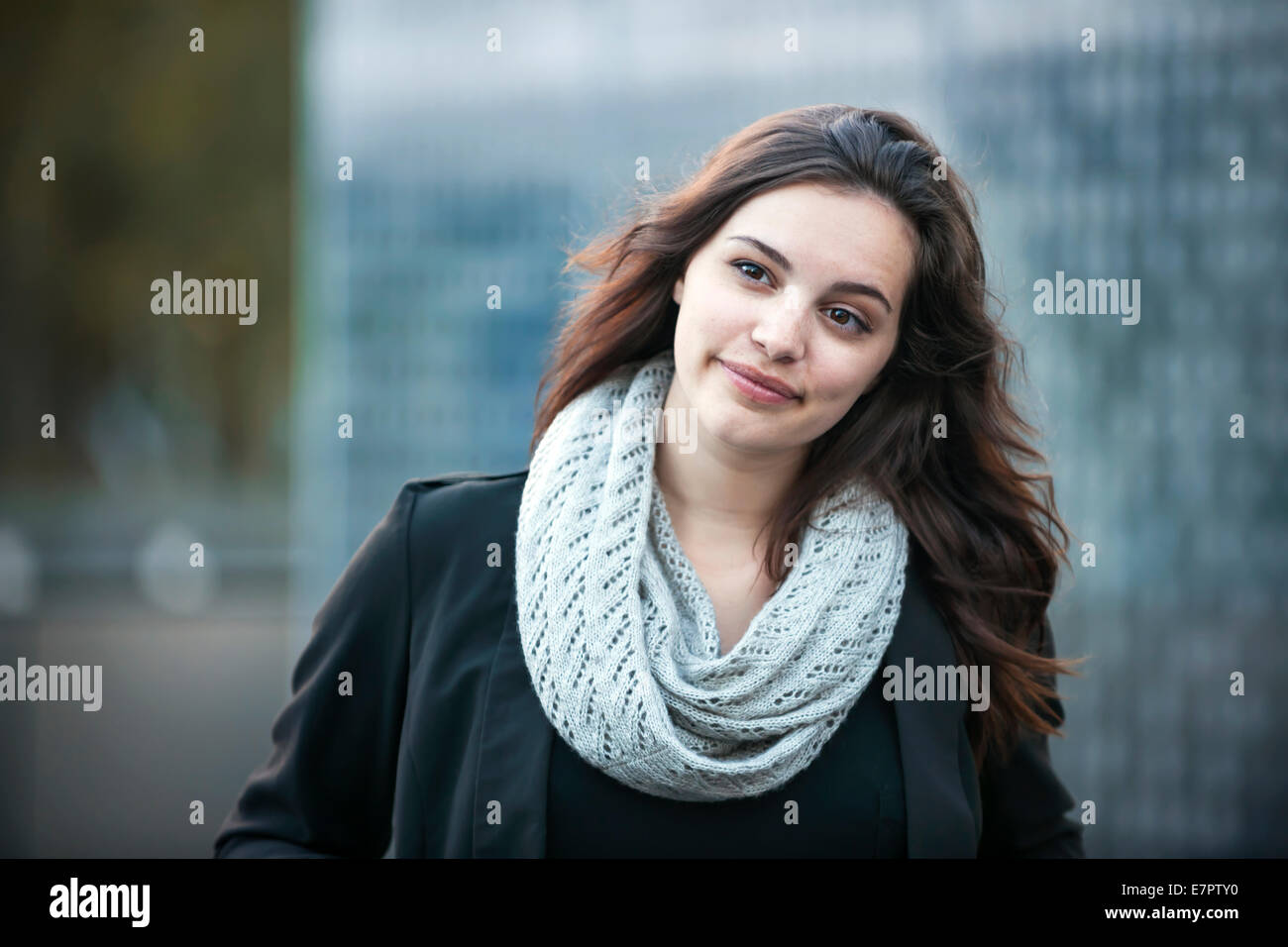 Candid portrait of young brunette woman looking away outside with copy space Stock Photo