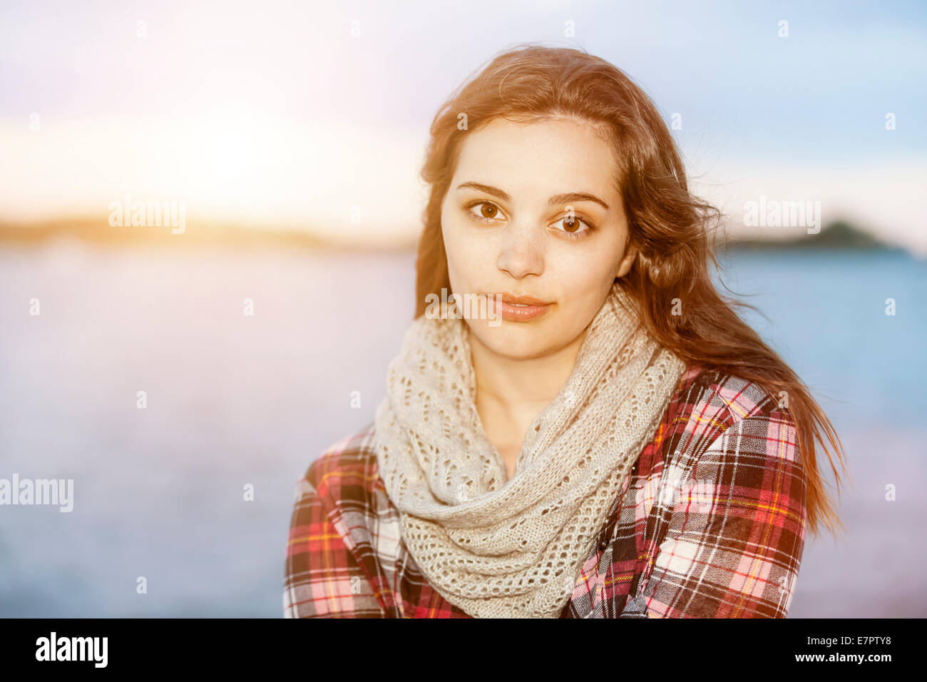 Portrait of young brunette woman near water looking at camera with copy space Stock Photo