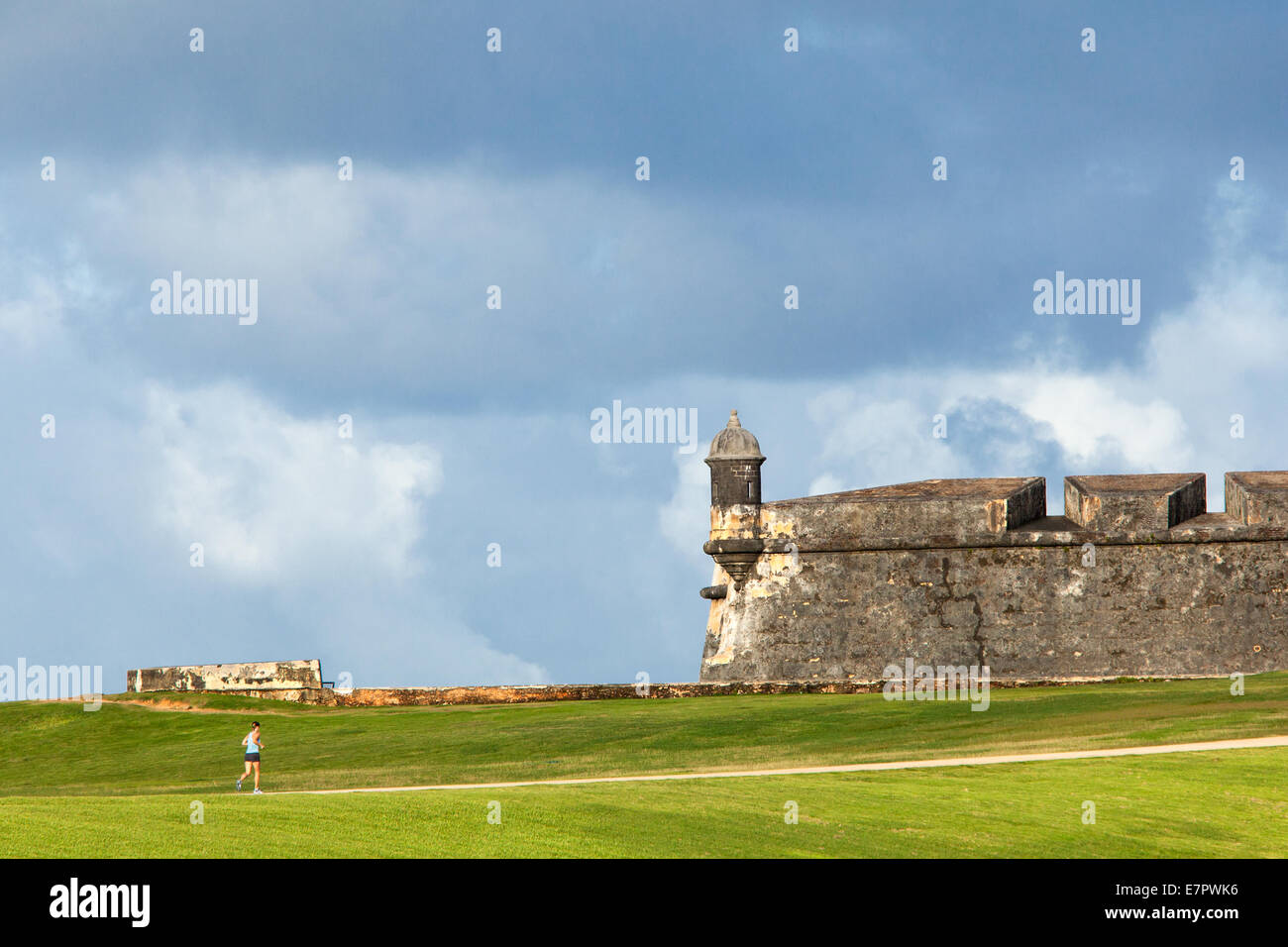 A woman runs near El Morro Fort, San Juan, Puerto Rico. Stock Photo
