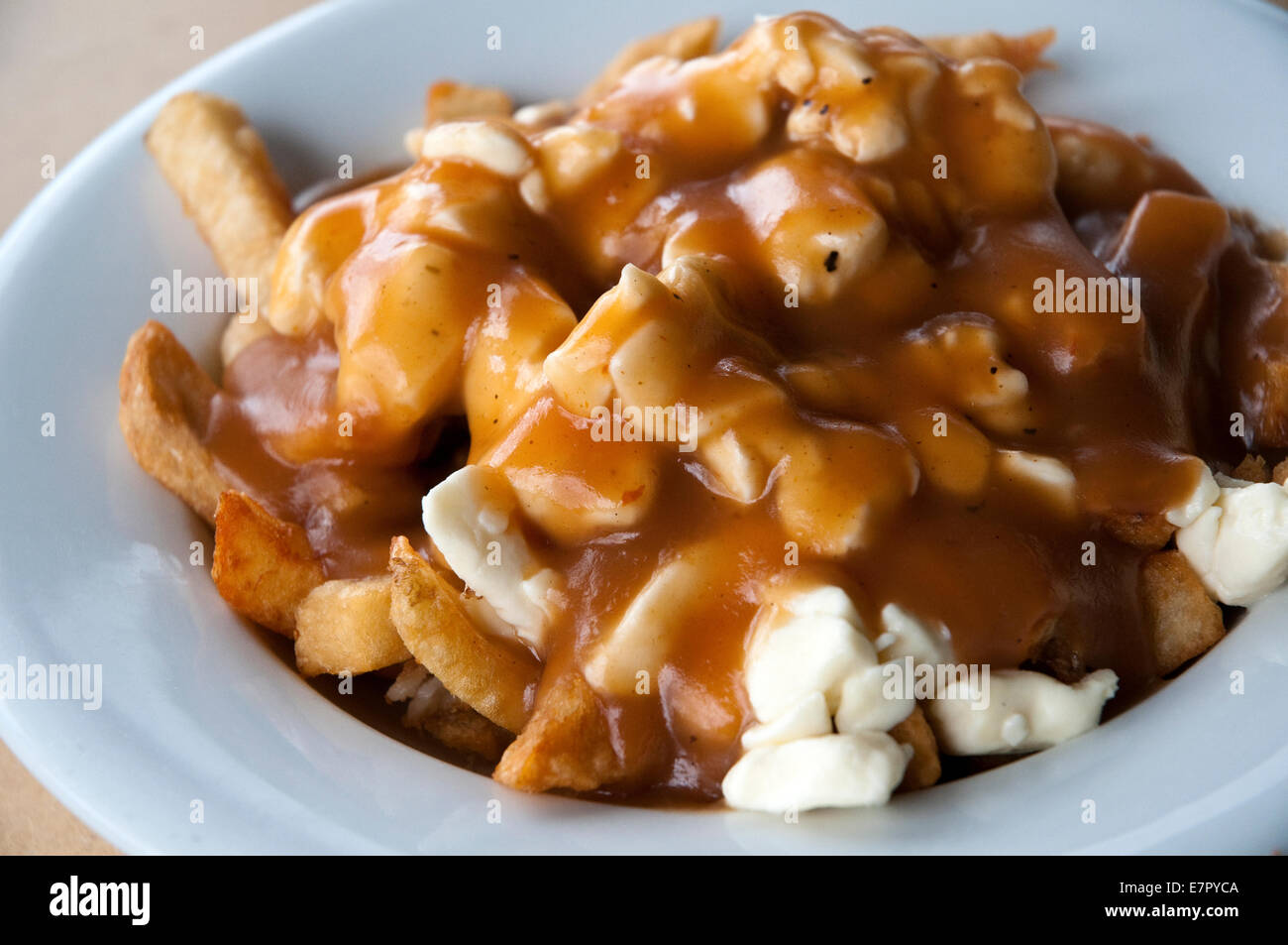 The famous 'traditional' poutine at Le Roy Jucep restaurant (the inventors of the dish) in Drummondville, Quebec, Canada. Stock Photo