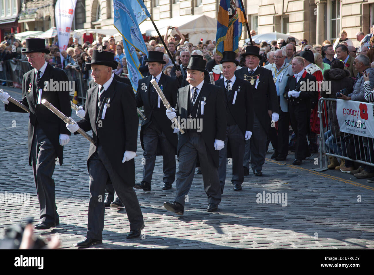 A procession of city fathers and elders marching in front of crowds on ...