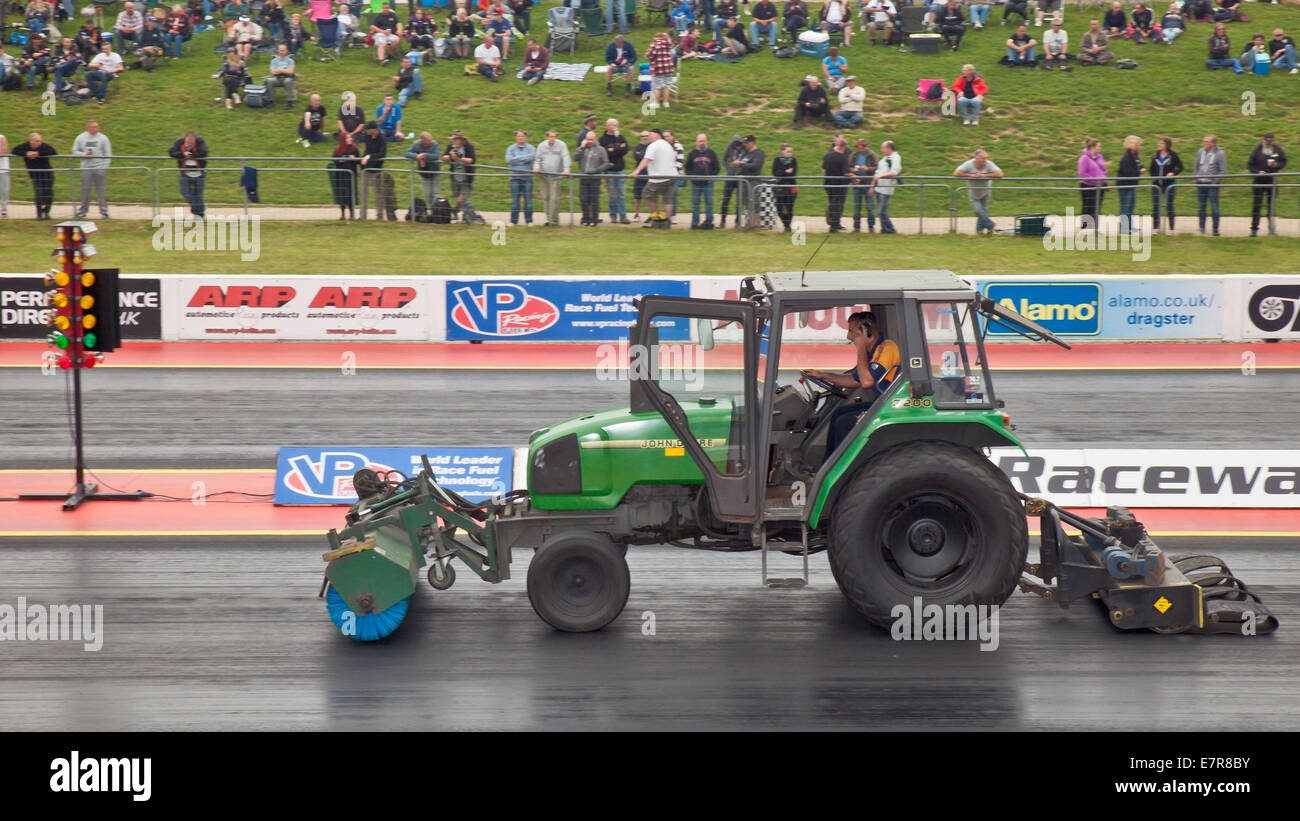 John Deere 3200 Tractor sweeping a racing track. Stock Photo