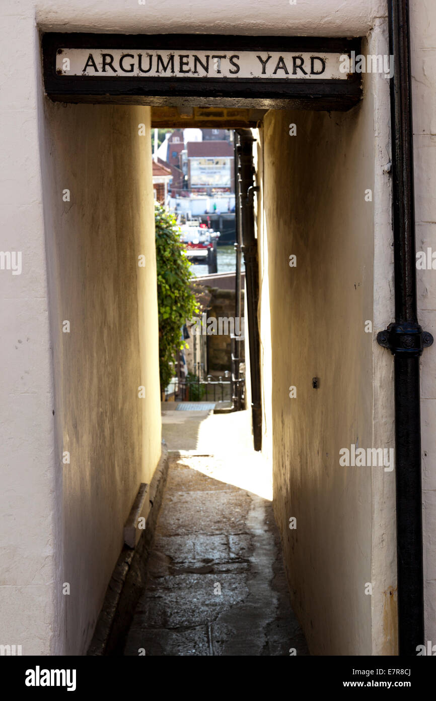 A small alleyway between two shops called Arguments Yard Stock Photo
