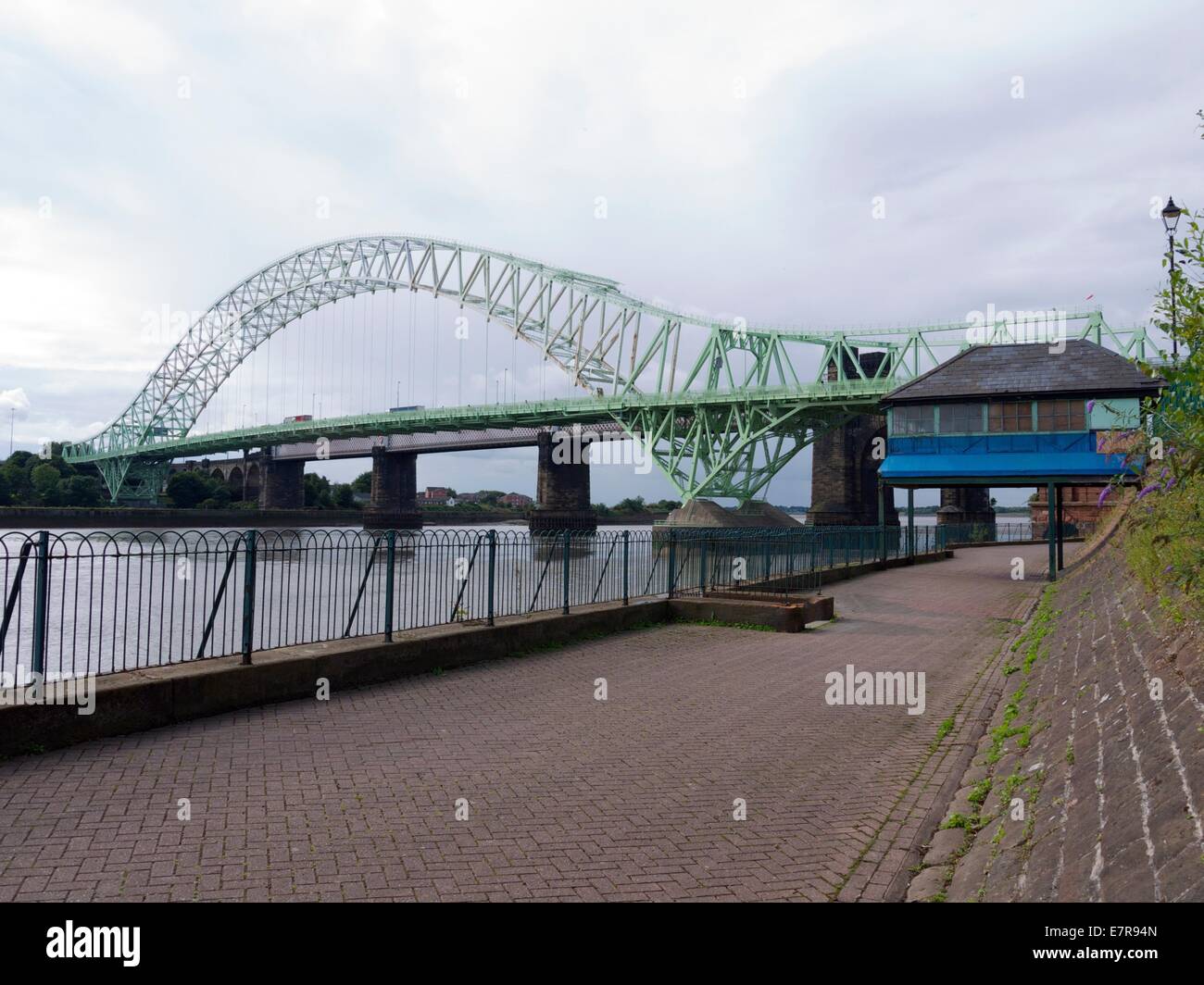 Runcorn Widnes road bridge across the river Mersey with a old Blue cabin in the foreground Stock Photo