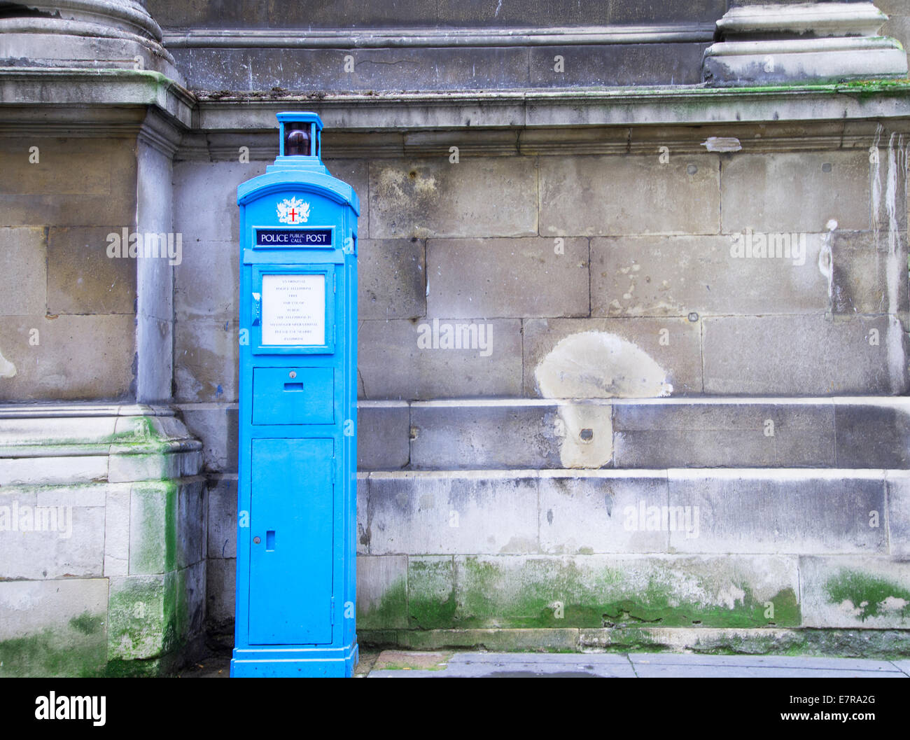 September 2014: Blue Police Telephone Box at the entrance to the Guild Hall courtyard, London, England Stock Photo