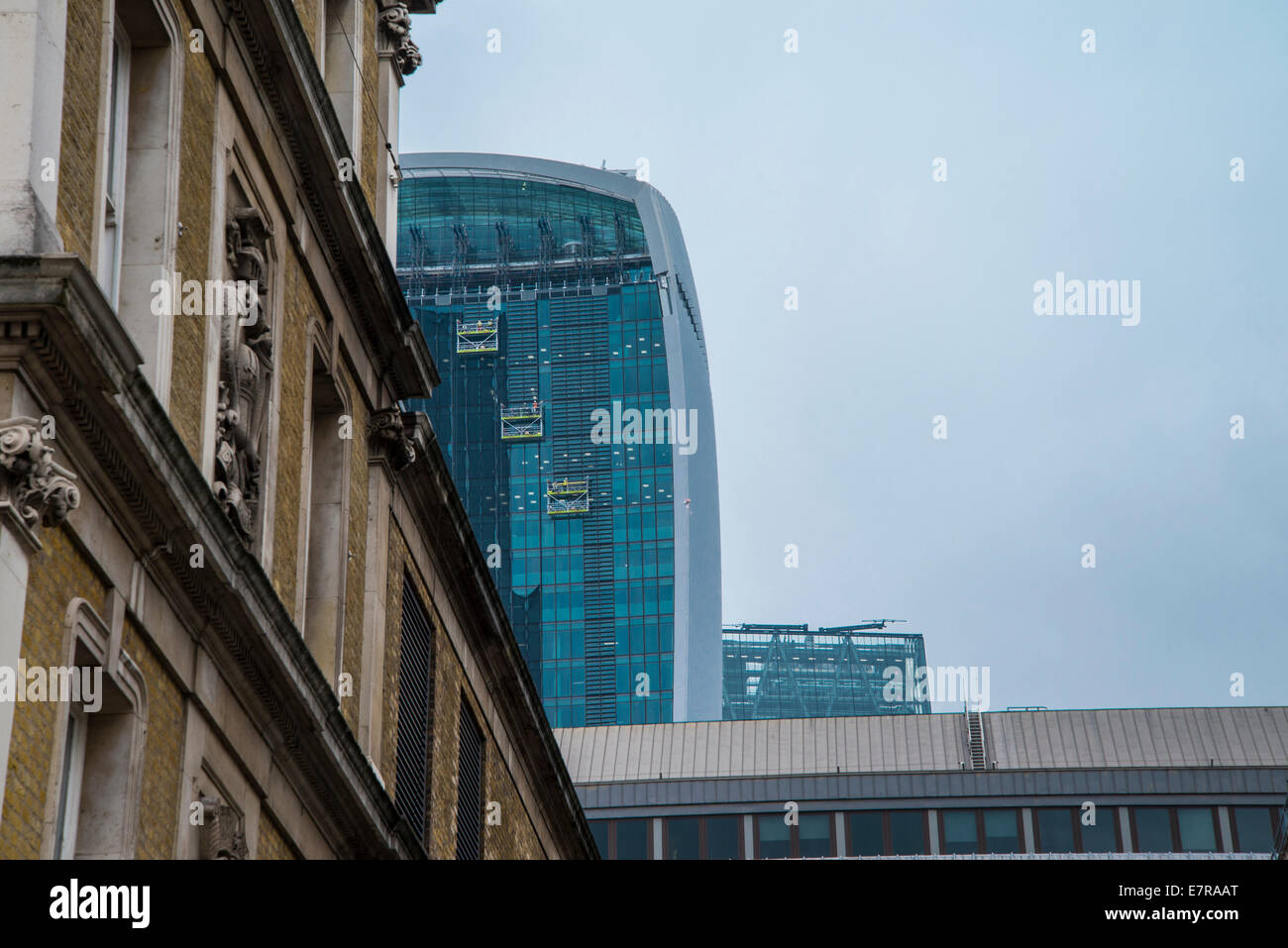 Autumn 2014: Walkie talkie building with three window cleaning cradles at Fenchurch Street, London, England. Stock Photo