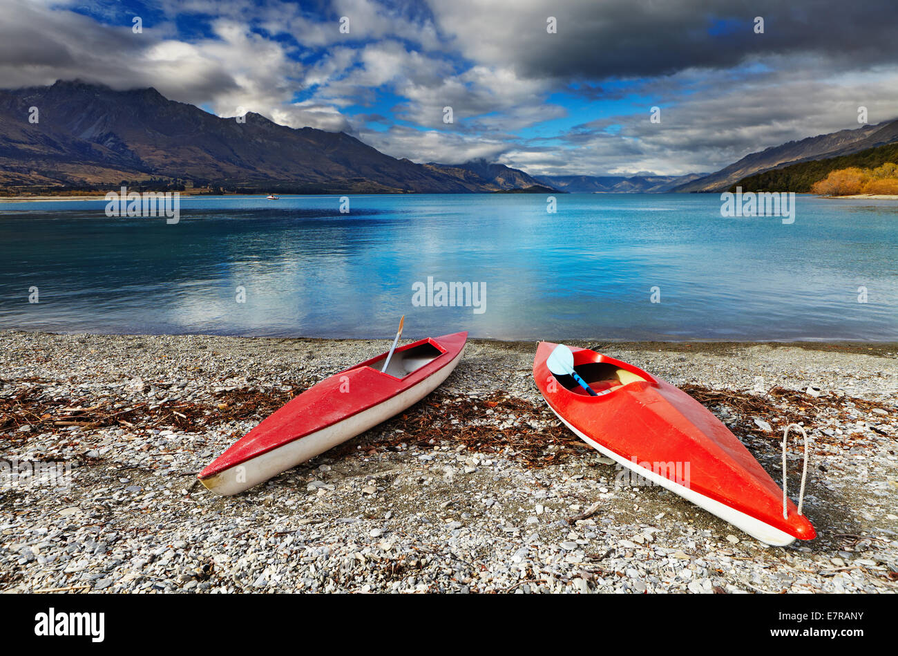 Red kayaks at the lakeside, Wakatipu Lake, New Zealand Stock Photo