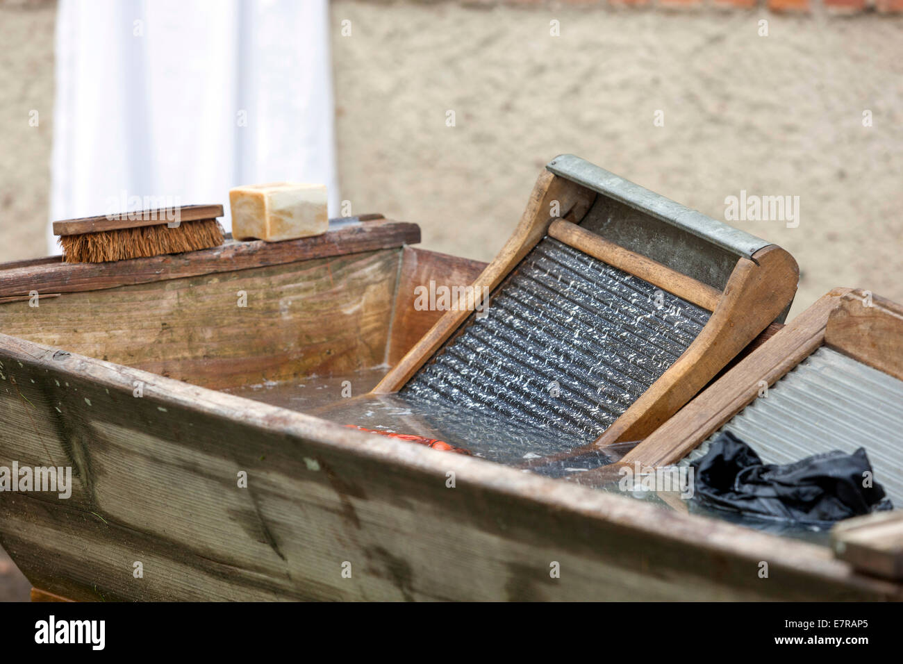 washing laundry at the old wooden washboard and wash tub clothing Stock Photo
