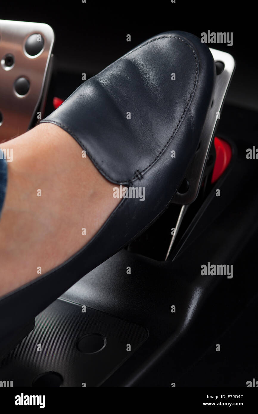 Woman's foot pressing the gas pedal Stock Photo Alamy
