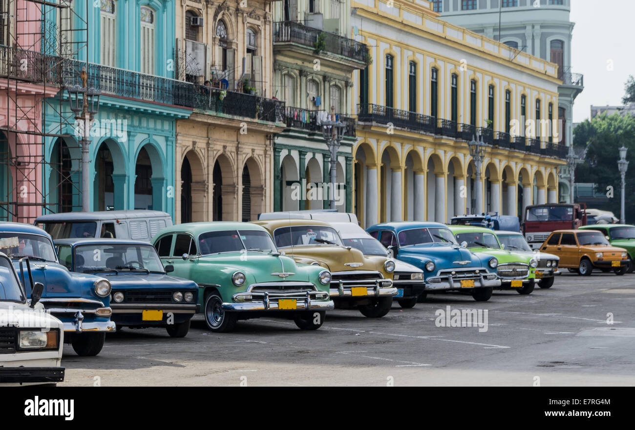 Street scene with vintage car and worn out buildings in Havana, Cuba. Stock Photo