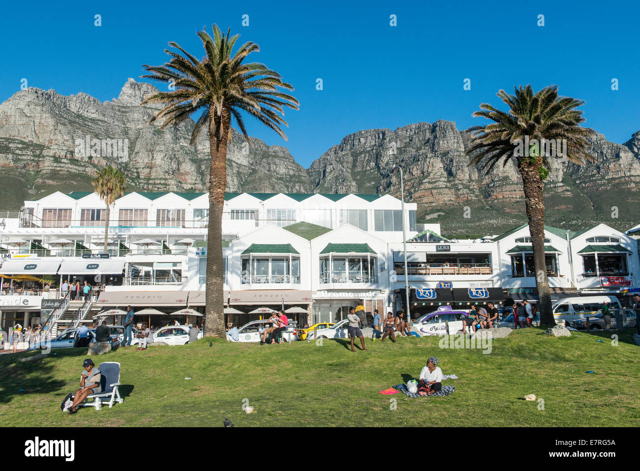Hotel and Table Mountain, people relaxing, Camps Bay, Cape Town, South Africa Stock Photo