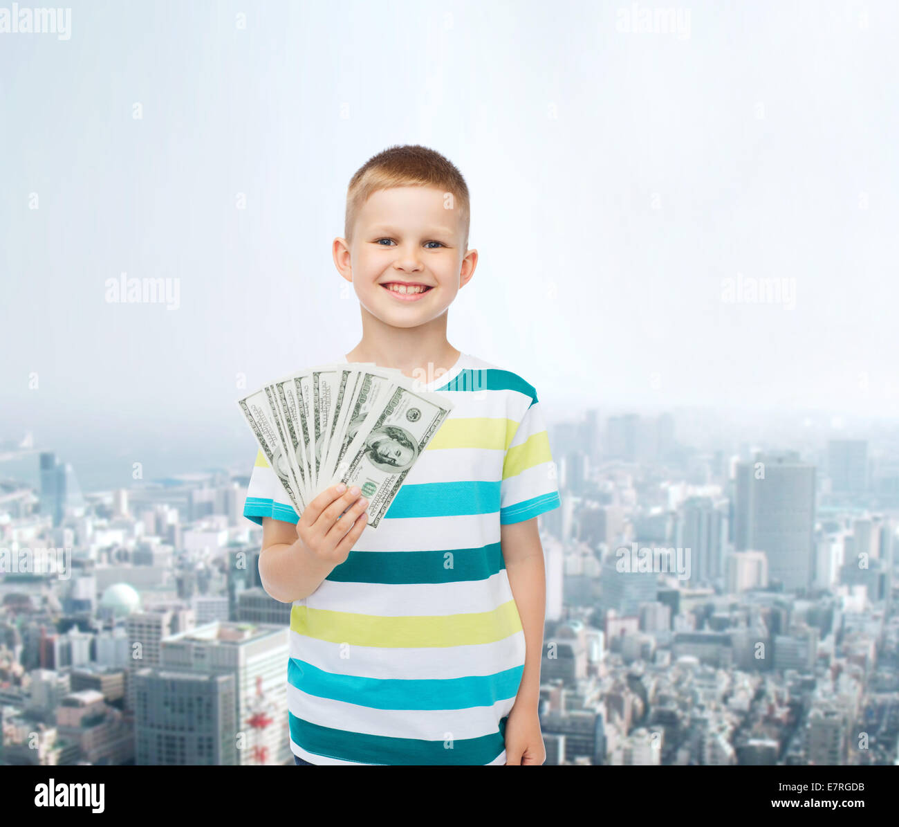 smiling boy holding dollar cash money in his hand Stock Photo - Alamy