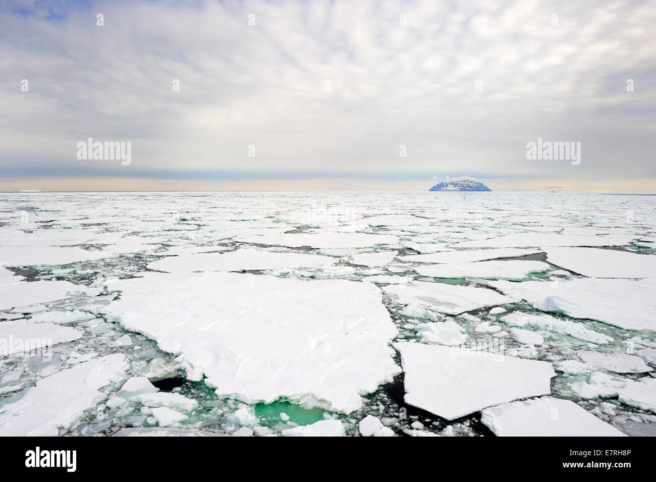 Small island in the Ross sea, Antarctica, with pack ice in the foreground. Stock Photo
