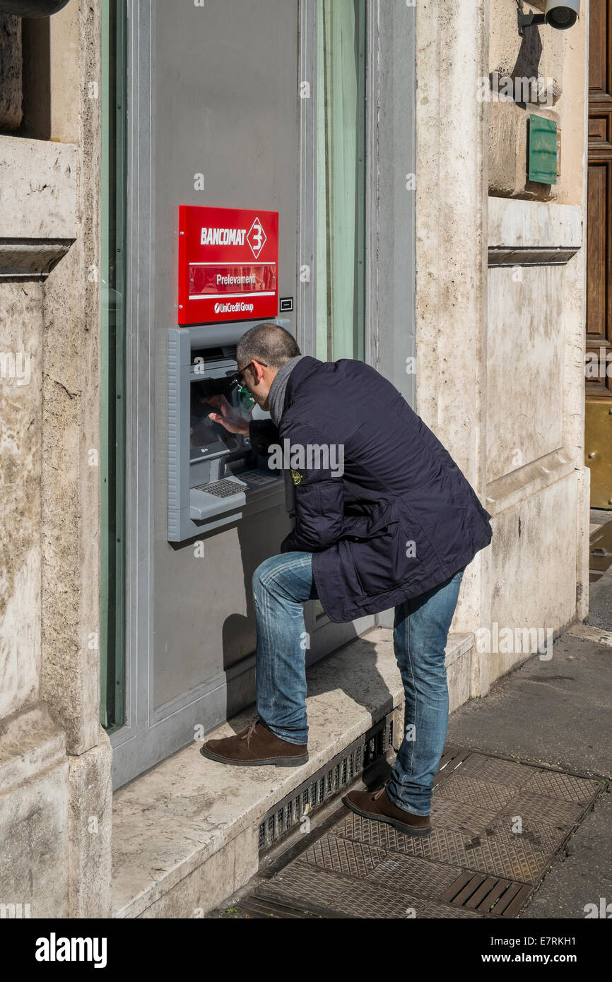 man at cash dispenser Stock Photo