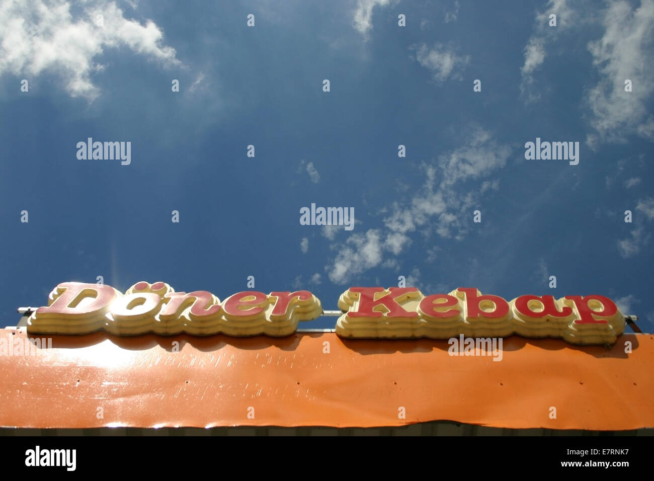 lettering doner kebab in orange letters before blue summer sky (popular fast-food i n germany), photo: July 11, 2006. Stock Photo
