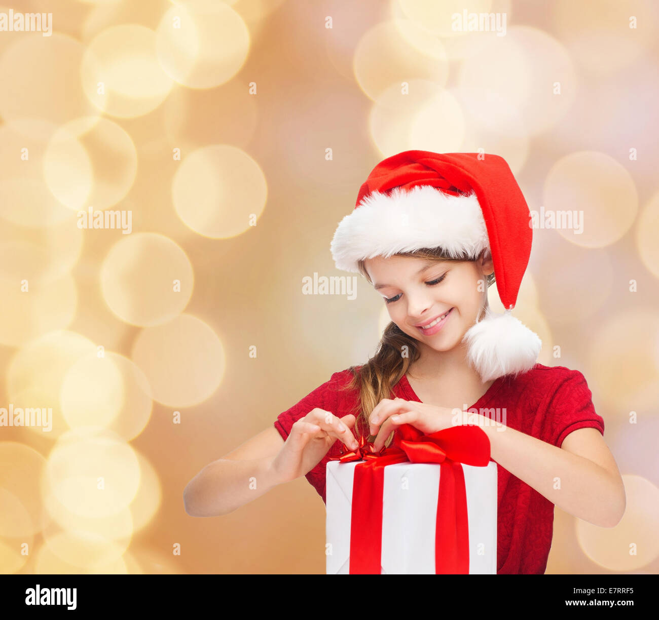 smiling girl in santa helper hat with gift box Stock Photo - Alamy
