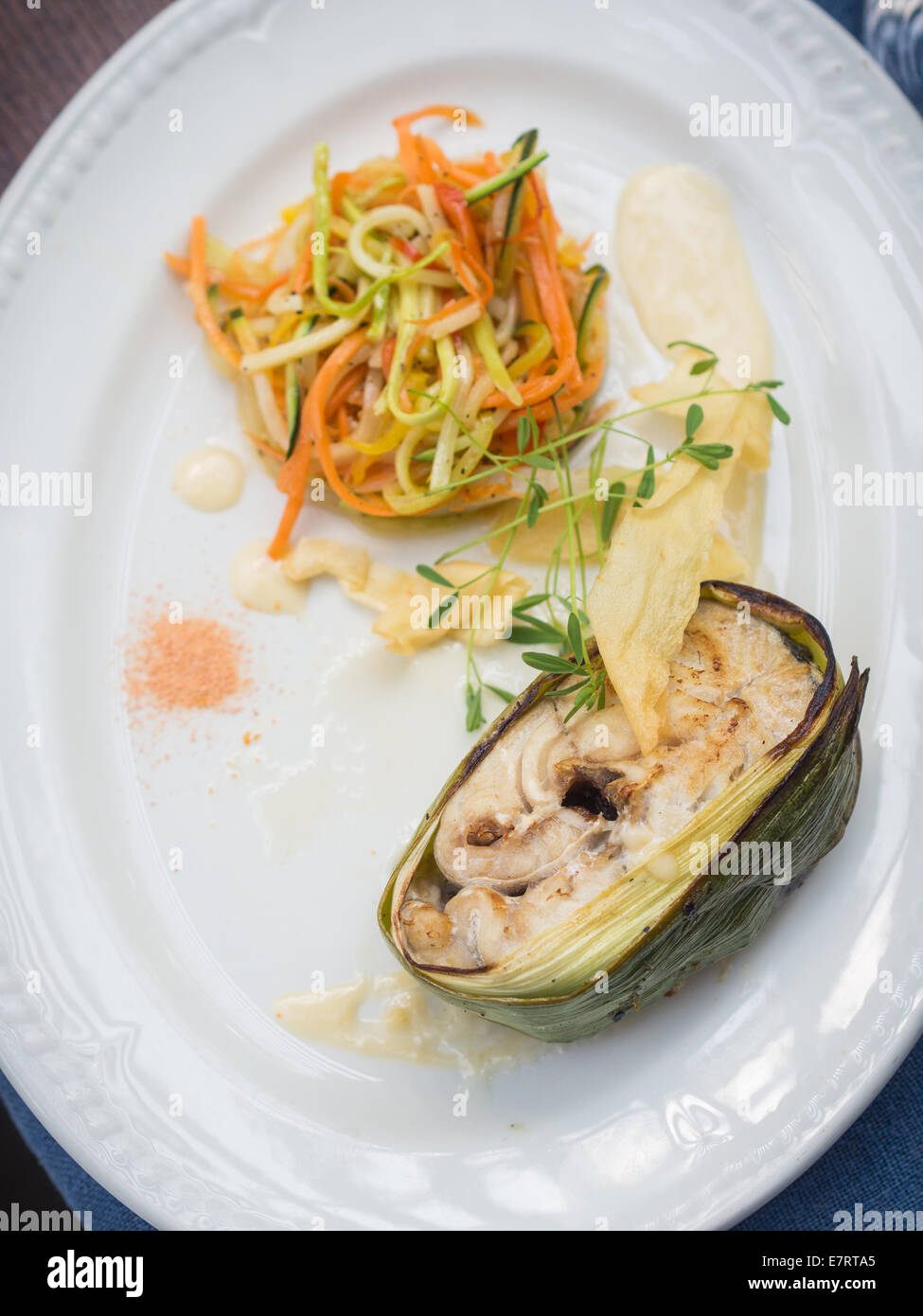 Leekwrapped fried haddock steak with steamed vegetable and whitewine
